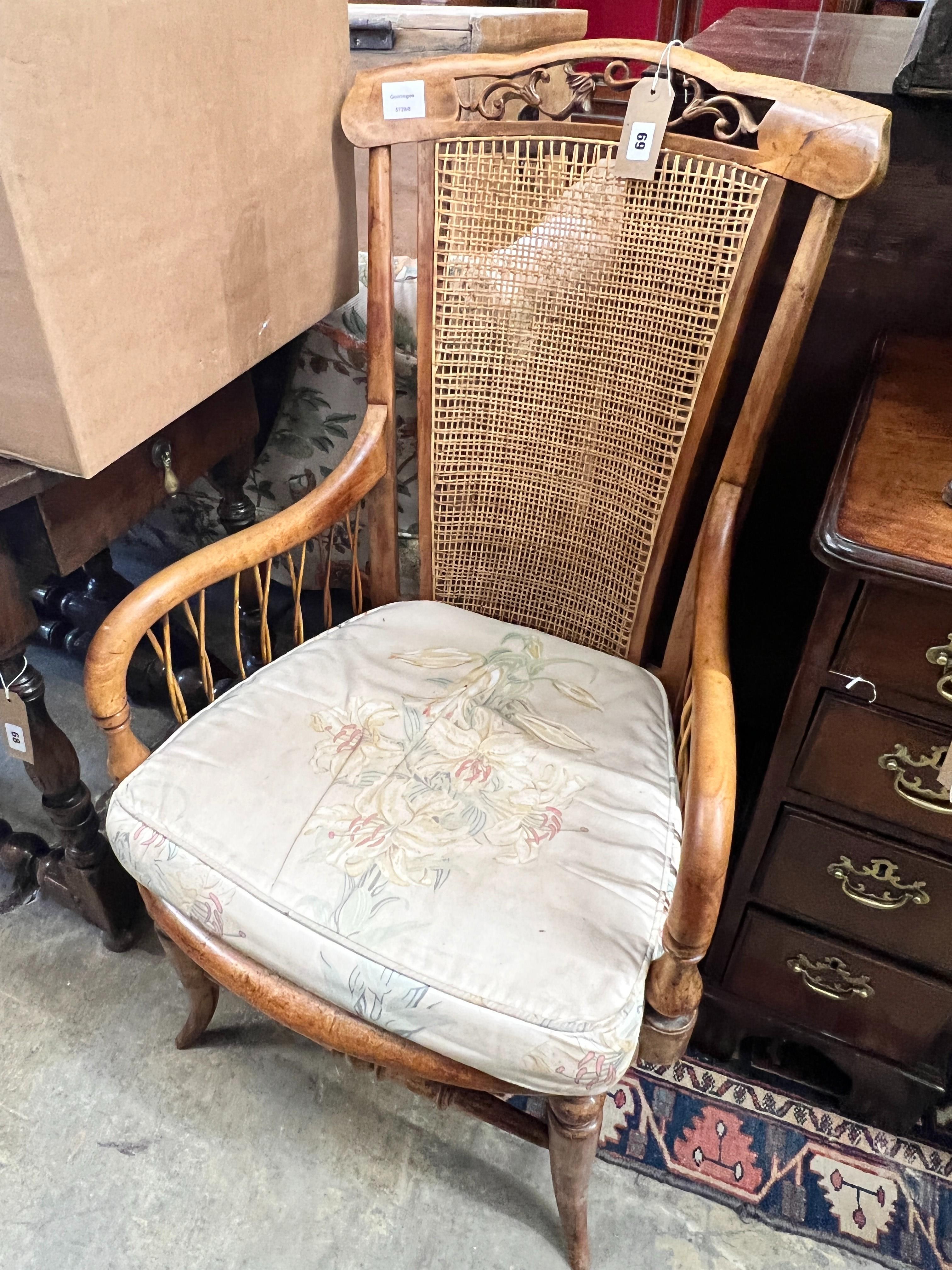 A Victorian maple framed caned back armchair